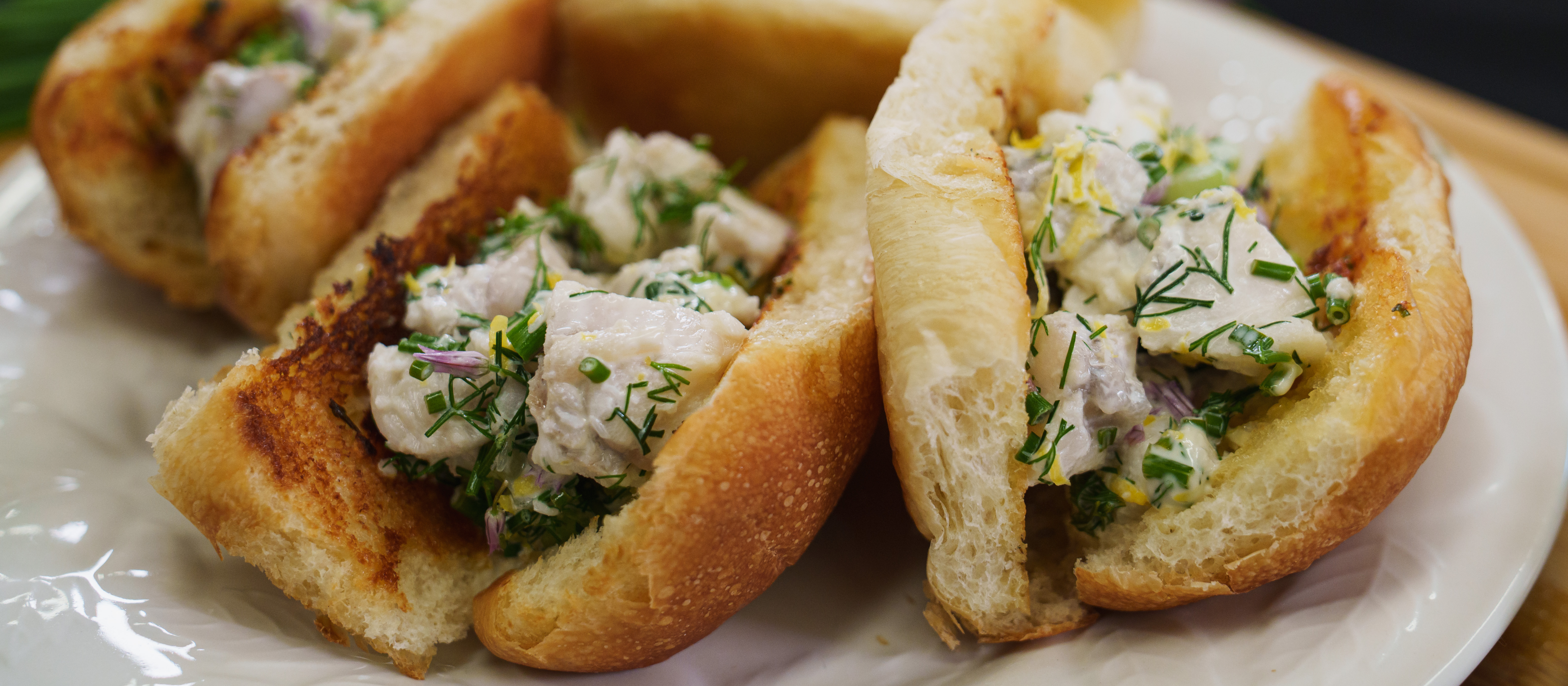 Monkfish rolls on a plate, ready to eat.