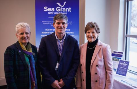 Dr. Erik Chapman standing alongside Senator Jeanne Shaheen and Marian McCord, Senior Vice Provost, at the New Hampshire Sea Grant Research Symposium.