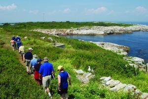 Folks walking a path on Appledore Island
