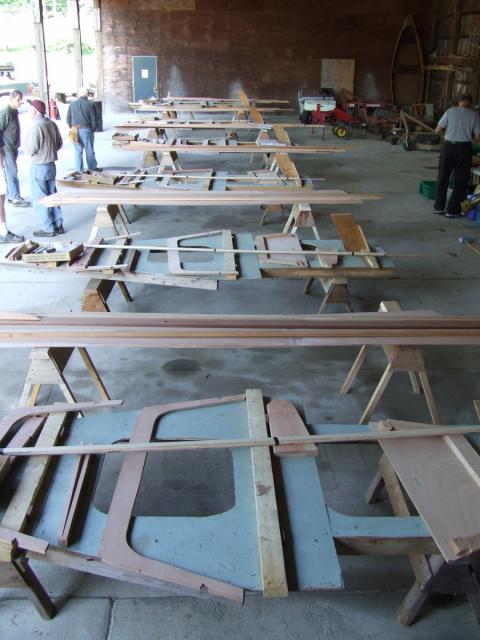 Boat parts laid out on sawhorses. 
