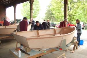 Family finishing building a boat