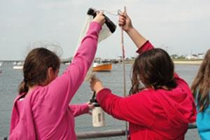 Two students taking a water sample