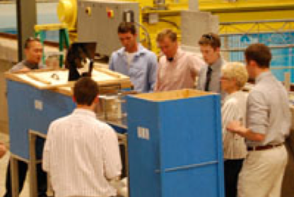 Students standing around a classroom