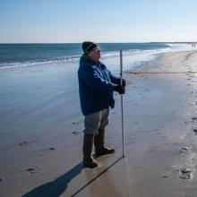 Man taking measurements on beach