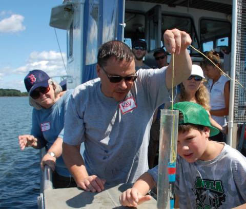 Boy helps with water on boat