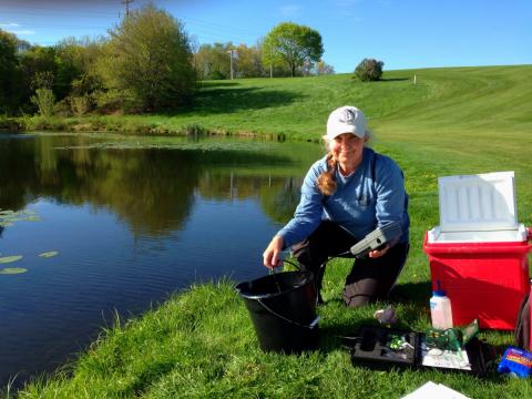 researcher collecting water samples