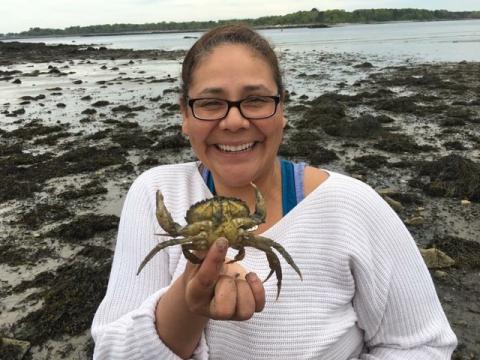 woman holding a green crab