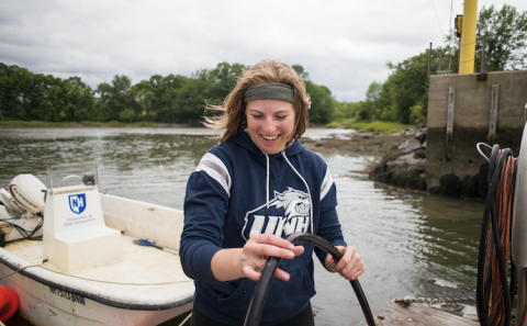 Woman on boat doing research