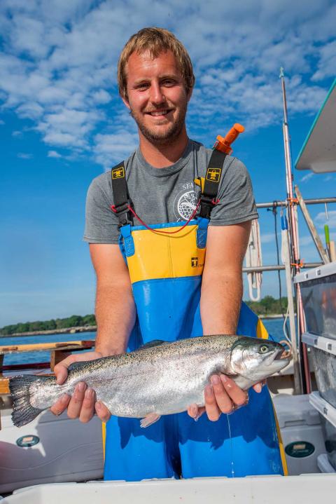 Aquaculture Project Manager Erich Berghan holds a large steelhead trout