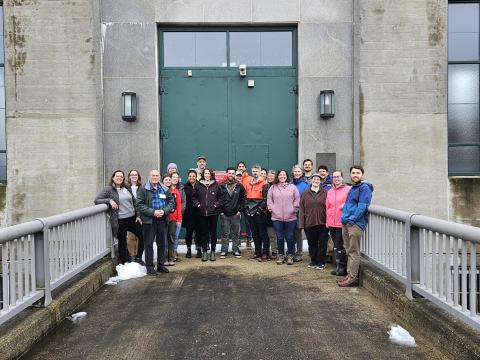 CoastWise participants stand outside in front of the Hopkinton-Everett Lakes Flood Management Project with US Army Corps staff 