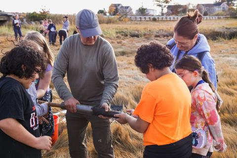 Students examine the core samples taken from the salt marsh.