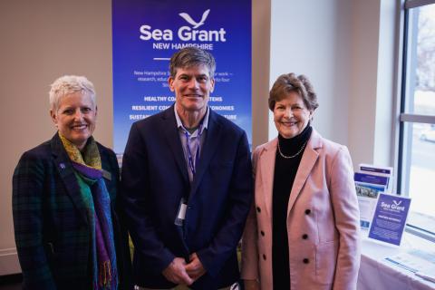 Dr. Erik Chapman standing alongside Senator Jeanne Shaheen and Marian McCord, Senior Vice Provost, at the New Hampshire Sea Grant Research Symposium.