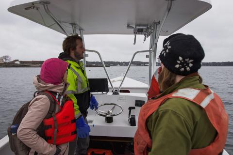 The group drives a vessel back to the UNH Pier, speaking about their experience together. 