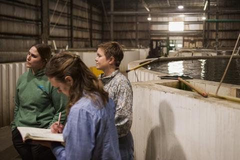Participants write down notes as the speaker from Great Falls Aquaculture discusses their operations. 