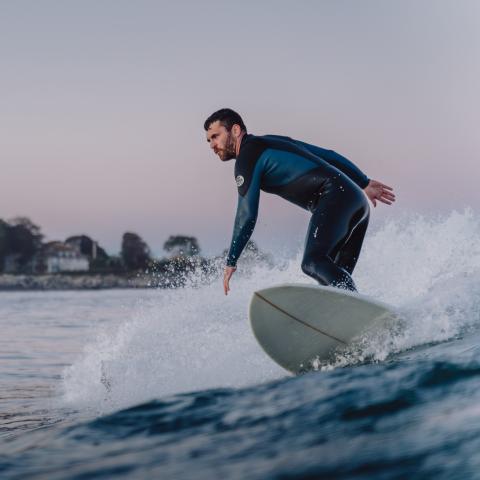 Brian Yurasits surfing a wave, as viewed from the water.