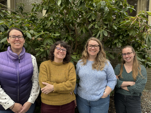 Four members of the Project Builder team stand together smiling at the camera.