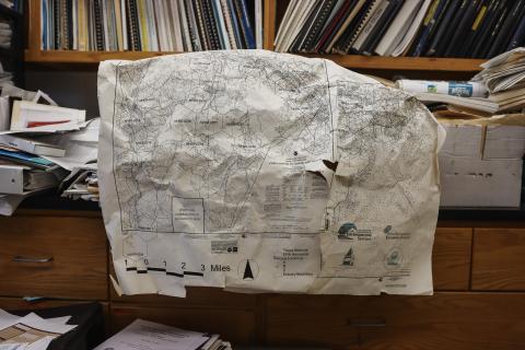 A map of Great Bay and NH waters on a bookshelf. 