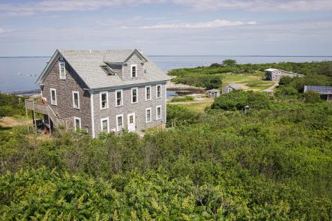 A view from the highest hill on Appledore Island, looking down at the island's buildings and coastline.