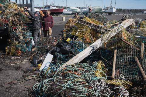 A massive pile of derelict lobster traps being unloaded at the harbor. 