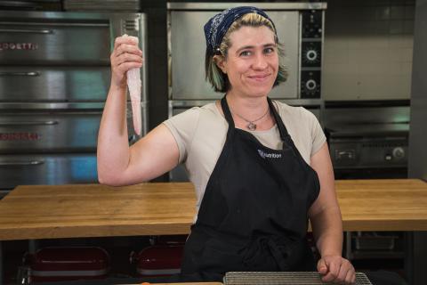 Chef Leah holding up a monkfish tail filet.
